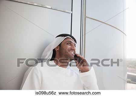 Stock Photo - Middle eastern man on cellphone. Fotosearch