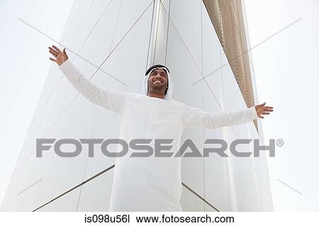Middle eastern man outside dubai building with arms open View Large Photo Image Stock Image - Middle eastern man outside dubai building with arms open. Fotosearch