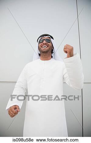 Stock Image - Middle eastern man punching the air. Fotosearch