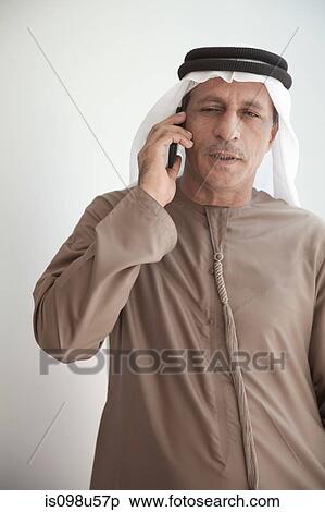 Middle eastern man using cellphone View Large Photo Image Stock Photography - Middle eastern man using cellphone. Fotosearch