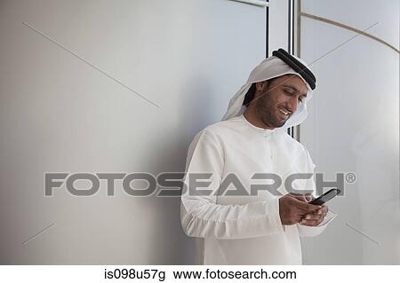 Middle eastern man with cellphone View Large Photo Image Stock Image - Middle eastern man with cellphone. Fotosearch