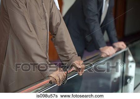 People holding railing View Large Photo Image Stock Photograph - People holding railing. Fotosearch