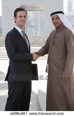 Western and middle eastern businessmen shaking hands View Large Photo Image Stock Image - Western and middle eastern businessmen shaking hands. Fotosearch