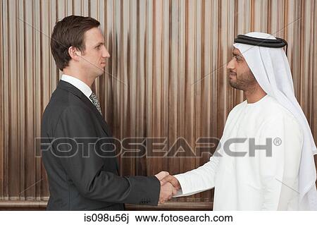 Western and middle eastern businessmen shaking hands View Large Photo Image Stock Image - Western and middle eastern businessmen shaking hands. Fotosearch