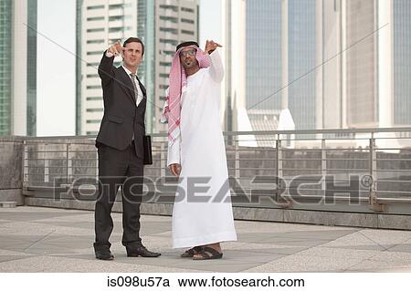 Western and middle eastern businessmen pointing View Large Photo Image Stock Image - Western and middle eastern businessmen pointing. Fotosearch