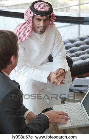 Western and middle eastern businessmen having meeting View Large Photo Image Stock Image - Western and middle eastern businessmen having meeting. Fotosearch
