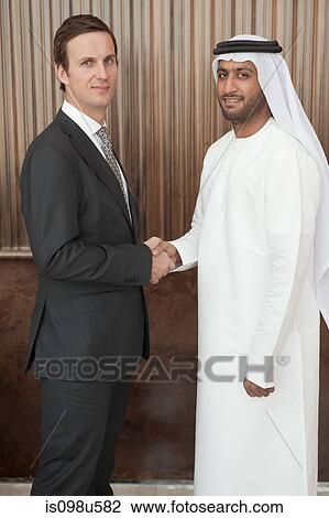 Western and middle eastern businessmen shaking hands View Large Photo Image Stock Image - Western and middle eastern businessmen shaking hands. Fotosearch
