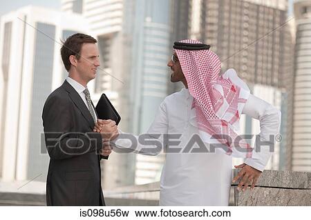 Western and middle eastern businessmen shaking hands View Large Photo Image Stock Photo - Western and middle eastern businessmen shaking hands. Fotosearch
