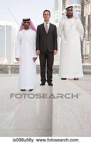 Stock Photo - Western and middle eastern businessmen in dubai. Fotosearch