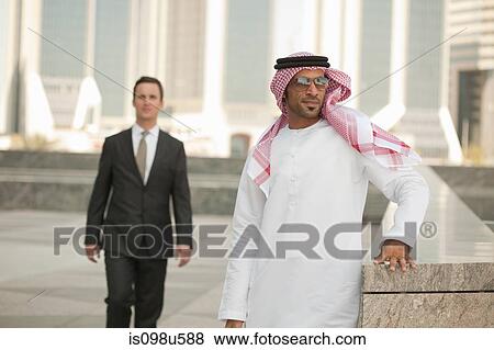 Stock Photo - Western and middle eastern businessmen in dubai. Fotosearch