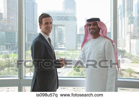 Western and middle eastern businessmen shaking hands View Large Photo Image Stock Photography - Western and middle eastern businessmen shaking hands. Fotosearch