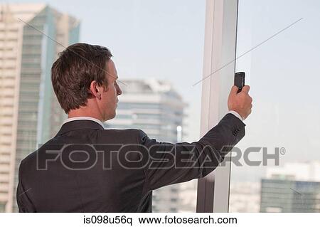 Western businessman using camera telephone View Large Photo Image Stock Photography - Western businessman using camera telephone. Fotosearch