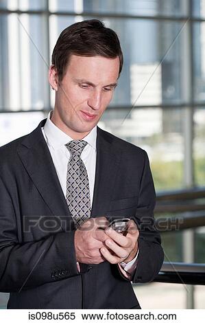 Western businessman using cellphone View Large Photo Image Stock Photography - Western businessman using cellphone. Fotosearch