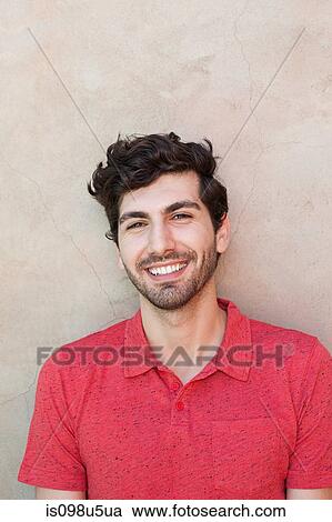 Portrait of young man in front of wall View Large Photo Image Stock Image - Portrait of young man in front of wall. Fotosearch