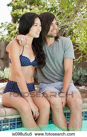 Young couple in swimming pool on vacation View Large Photo Image Stock Photography - Young couple in swimming pool on vacation. Fotosearch