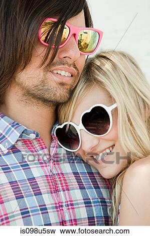 Stock Photo - Young couple wearing sunglasses. Fotosearch