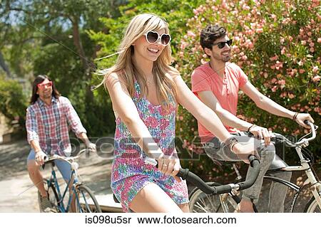 Young friends cycling on vacation View Large Photo Image Stock Photography - Young friends cycling on vacation. Fotosearch