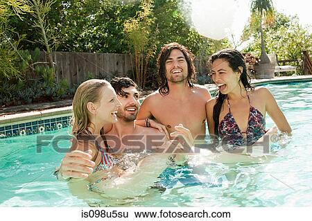 Young friends in swimming pool on vacation View Large Photo Image Stock Photograph - Young friends in swimming pool on vacation. Fotosearch