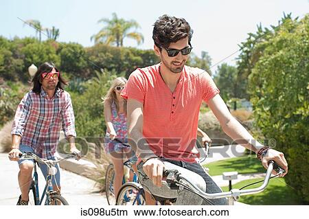 Picture - Young friends on bicycles on vacation. Fotosearch