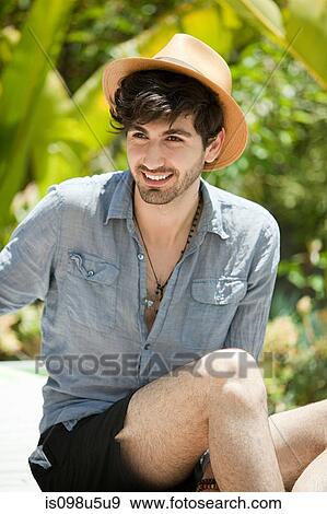 Young man wearing throwing trilby View Large Photo Image Stock Photo - Young man wearing throwing trilby. Fotosearch