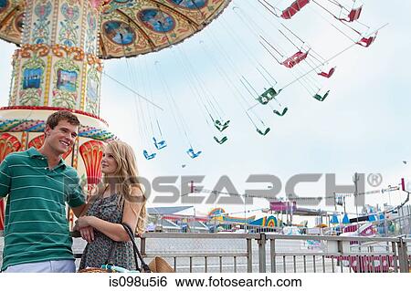 Teenage couple at amusement park View Large Photo Image Stock Photograph - Teenage couple at amusement park. Fotosearch