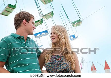 Teenage couple at fun fair View Large Photo Image Stock Image - Teenage couple at fun fair. Fotosearch