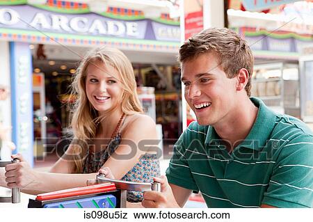 Teenage couple at shooting gallery View Large Photo Image Stock Photo - Teenage couple at shooting gallery. Fotosearch