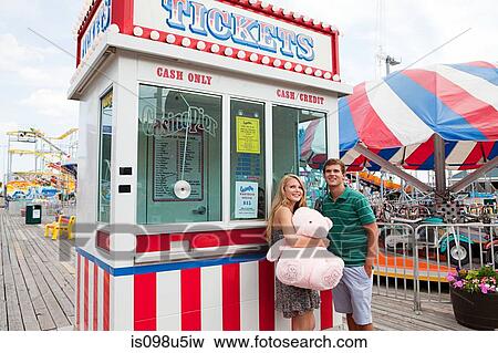 Teenage couple at ticket booth on pier View Large Photo Image Stock Photo - Teenage couple at ticket booth on pier. Fotosearch