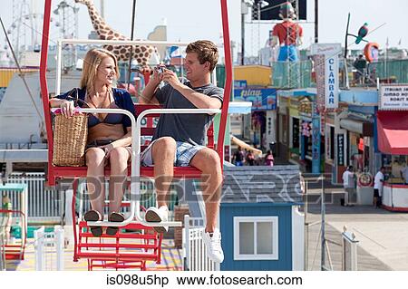 Teenage couple on ferris wheel View Large Photo Image Stock Photography - Teenage couple on ferris wheel. Fotosearch