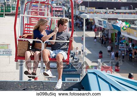 Teenage couple on ferris wheel View Large Photo Image Stock Photography - Teenage couple on ferris wheel. Fotosearch