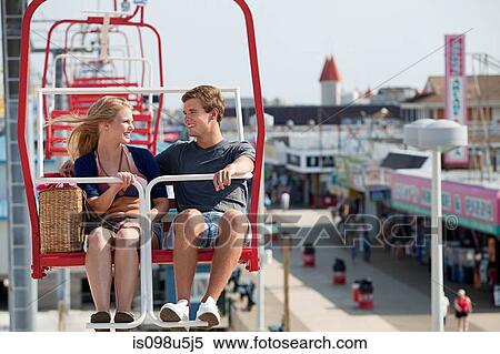 Teenage couple on ferris wheel View Large Photo Image Stock Photography - Teenage couple on ferris wheel. Fotosearch