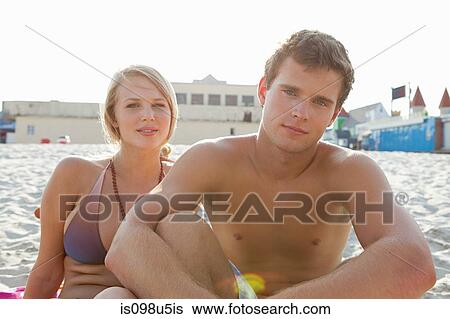 Stock Photograph - Teenage couple on the beach. Fotosearch