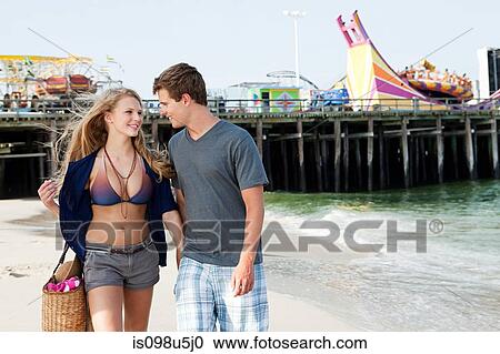 Teenage couple walking on beach View Large Photo Image Stock Image - Teenage couple walking on beach. Fotosearch