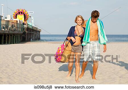 Teenage couple walking on beach View Large Photo Image Stock Photo - Teenage couple walking on beach. Fotosearch