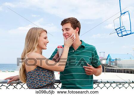 Teenage couple with snow cone View Large Photo Image Stock Image - Teenage couple with snow cone. Fotosearch