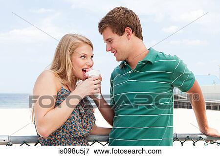 Teenage couple with snow cone View Large Photo Image Stock Photo - Teenage couple with snow cone. Fotosearch