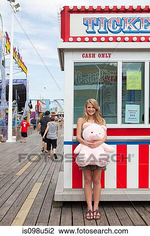 Teenage girl by ticket booth with teddy bear View Large Photo Image Stock Image - Teenage girl by ticket booth with teddy bear. Fotosearch