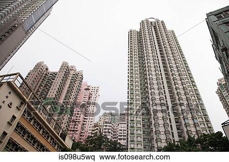 Stock Photography - Hong kong, low angle view of apartment buildings. Fotosearch