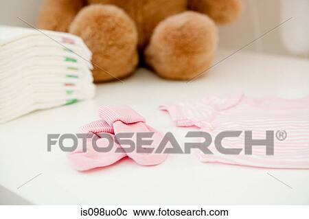 Stock Image - Baby clothes and bear. Fotosearch