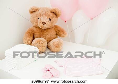Baby clothes and teddy bear View Large Photo Image Stock Photo - Baby clothes and teddy bear. Fotosearch