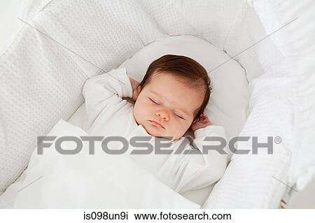 Baby sleeping in a bassinet View Large Photo Image Stock Image - Baby sleeping in a bassinet. Fotosearch