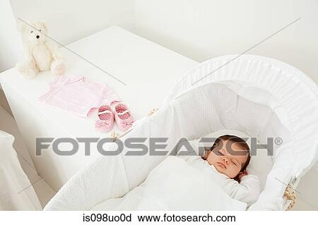 Baby sleeping in a bassinet View Large Photo Image Stock Image - Baby sleeping in a bassinet. Fotosearch