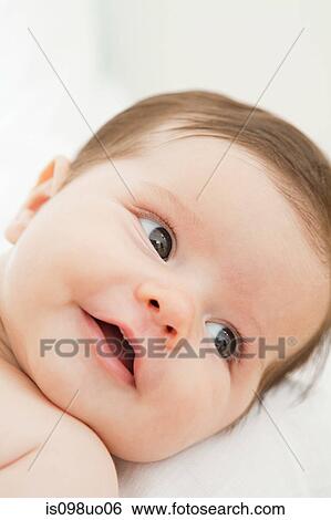 Stock Photograph - Close up of face of baby girl. Fotosearch