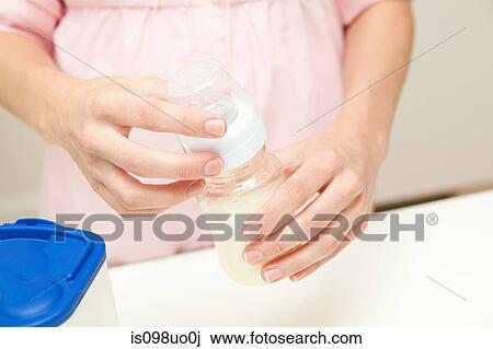 Close up of mother preparing baby formula View Large Photo Image Stock Image - Close up of mother preparing baby formula. Fotosearch