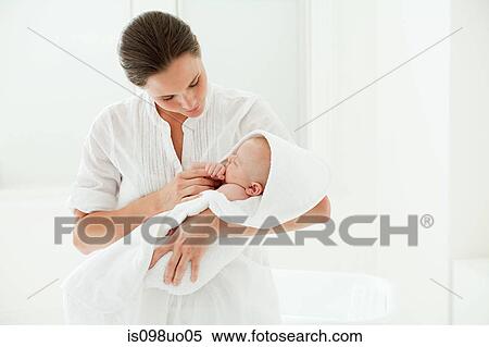 Stock Photography - Mother and baby son wrapped in towel. Fotosearch