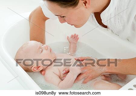 Mother bathing baby View Large Photo Image Stock Photo - Mother bathing baby. Fotosearch