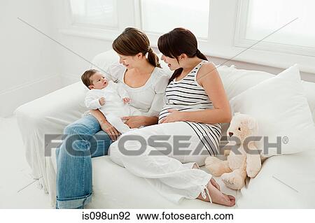 Mother with baby girl and pregnant friend View Large Photo Image Stock Image - Mother with baby girl and pregnant friend. Fotosearch