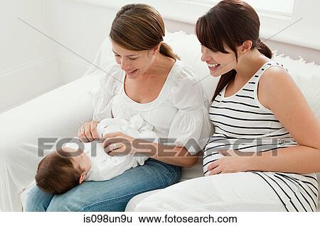 Mother with baby girl and pregnant friend View Large Photo Image Stock Photograph - Mother with baby girl and pregnant friend. Fotosearch