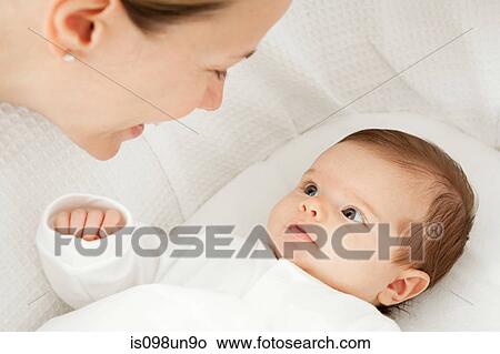 Mother with baby in bassinet View Large Photo Image Picture - Mother with baby in bassinet. Fotosearch