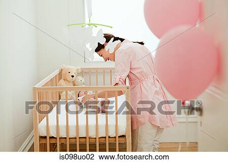 Mother with baby in crib View Large Photo Image Stock Image - Mother with baby in crib. Fotosearch
